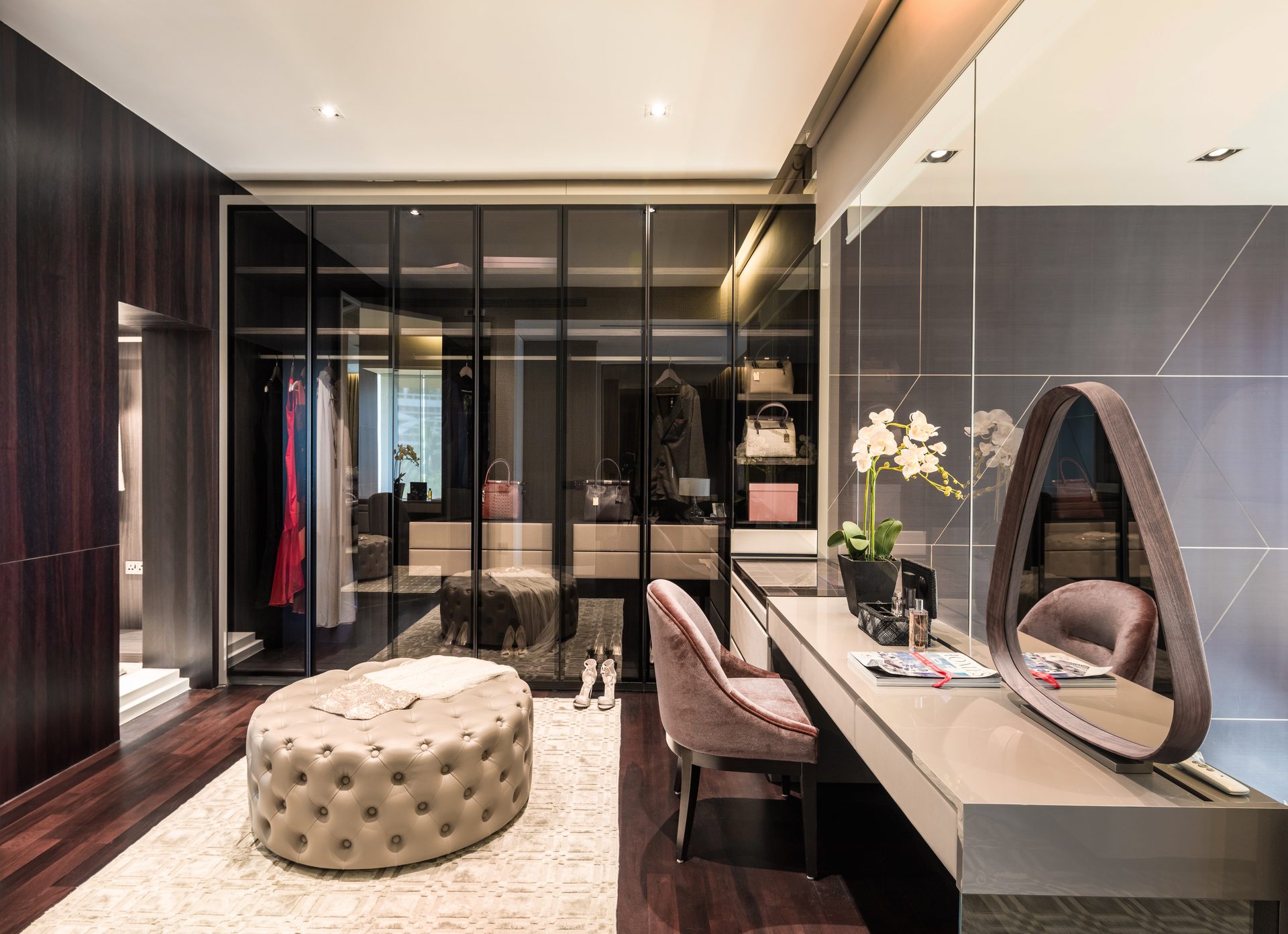 Walk-in wardrobe with glass-front closets and display shelving